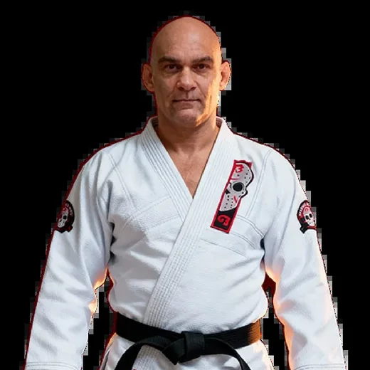 Master Roberto Godoi, founder of G13, in a white gi with a black belt